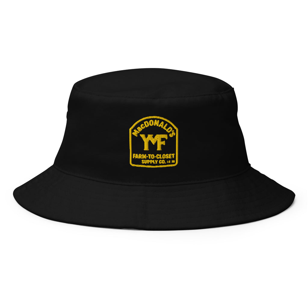 YMF Farm-to-Closet Bucket Hat — black organic cotton twill with gold MacDonald's Farm-to-Closet Supply Co. crest, front view