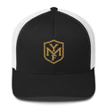 YMF Classic Trucker Hat — black and white mesh trucker with gold embroidered YMF shield monogram, front view